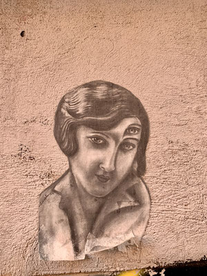 Street art of young woman with third eye on forehead