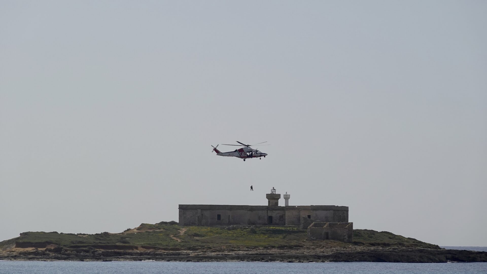 Man rappels down from helicopter