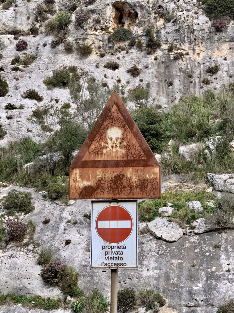 Weathered danger sign with skull and crossbones